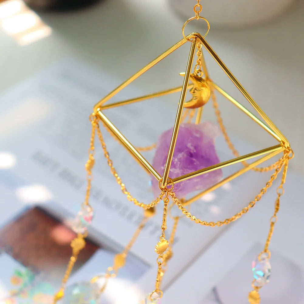 Gold geometric hanging ornament with crystals on a blurred background