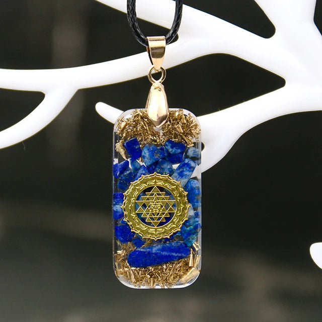 Pendant with blue and gold design on a white background