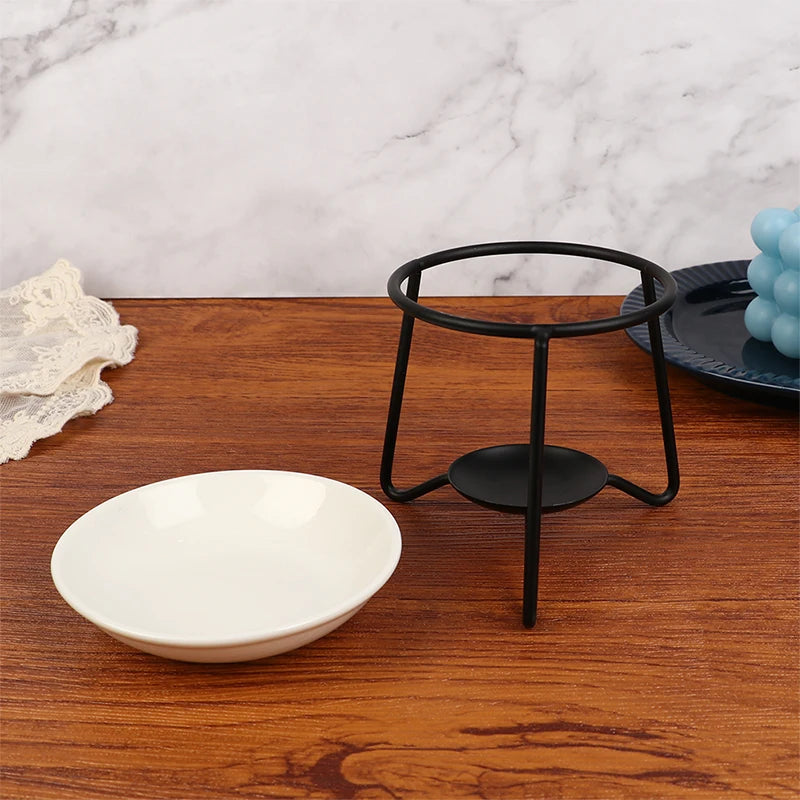 White bowl and black metal stand on a wooden surface with a marble background
