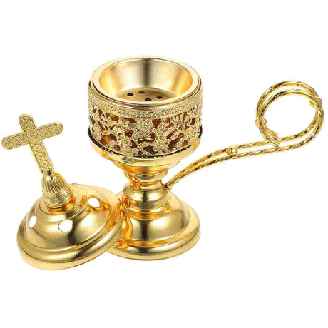 Gold incense burner with cross design on a white background