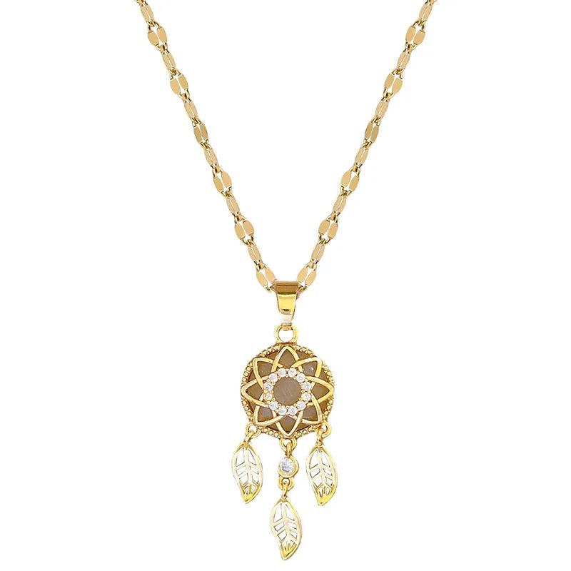 Gold necklace with a dreamcatcher pendant on a white background