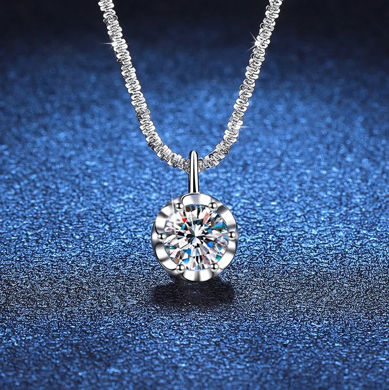 Silver necklace with a round diamond pendant on a blue textured background