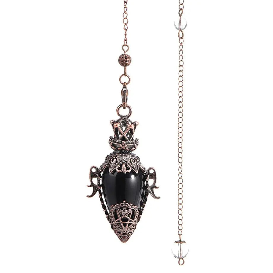 Decorative pendant with black stone and intricate design on a chain against a white background