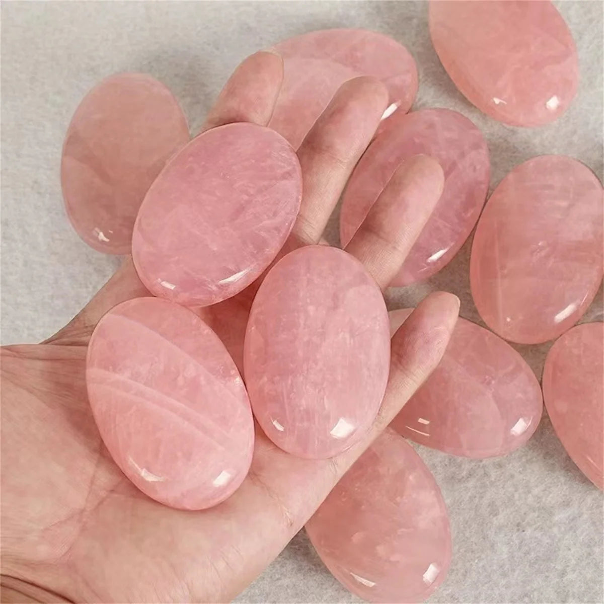 Pink stones on a hand with a neutral background