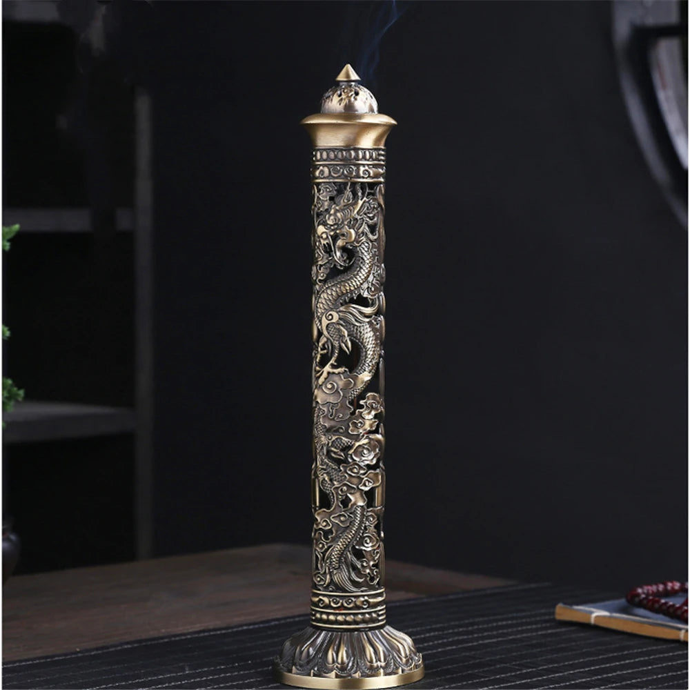 Decorative incense holder with intricate designs on a dark background