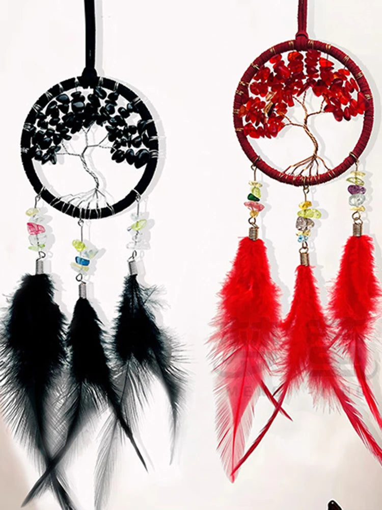 Two dream catchers, one black and white, the other red and black, with feathers and beads.