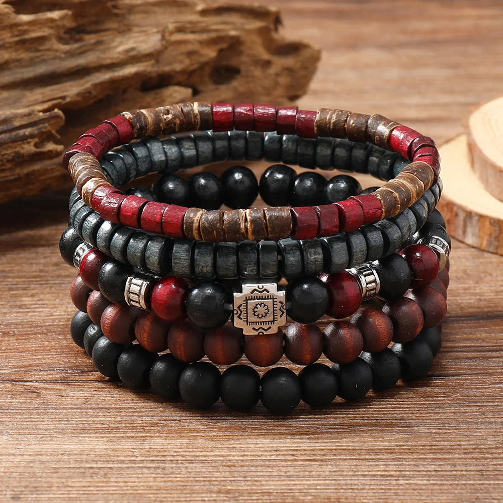 Stack of beaded bracelets with red, black, and brown colors on a wooden surface.