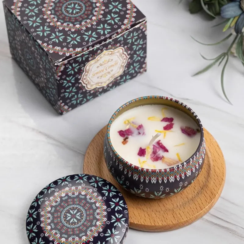 Decorative candle in a patterned container with a matching lid on a white surface.
