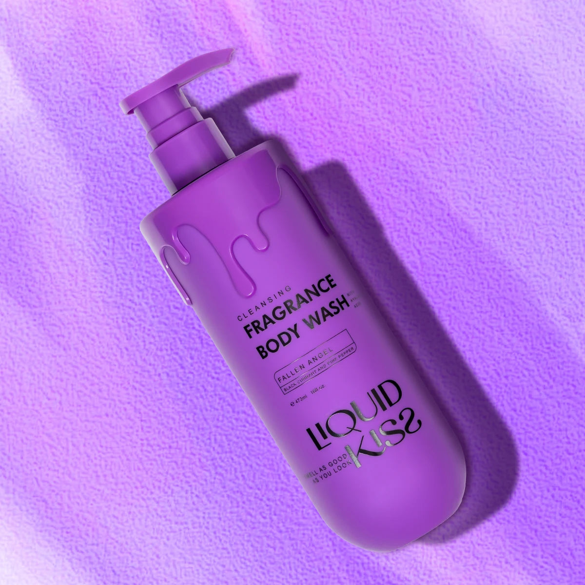 Purple bottle of Liquid Kiss fragrance body wash on a purple background