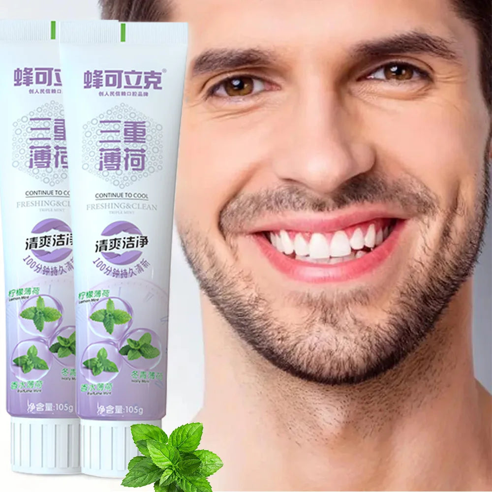 Two toothpaste tubes with a man smiling in the background