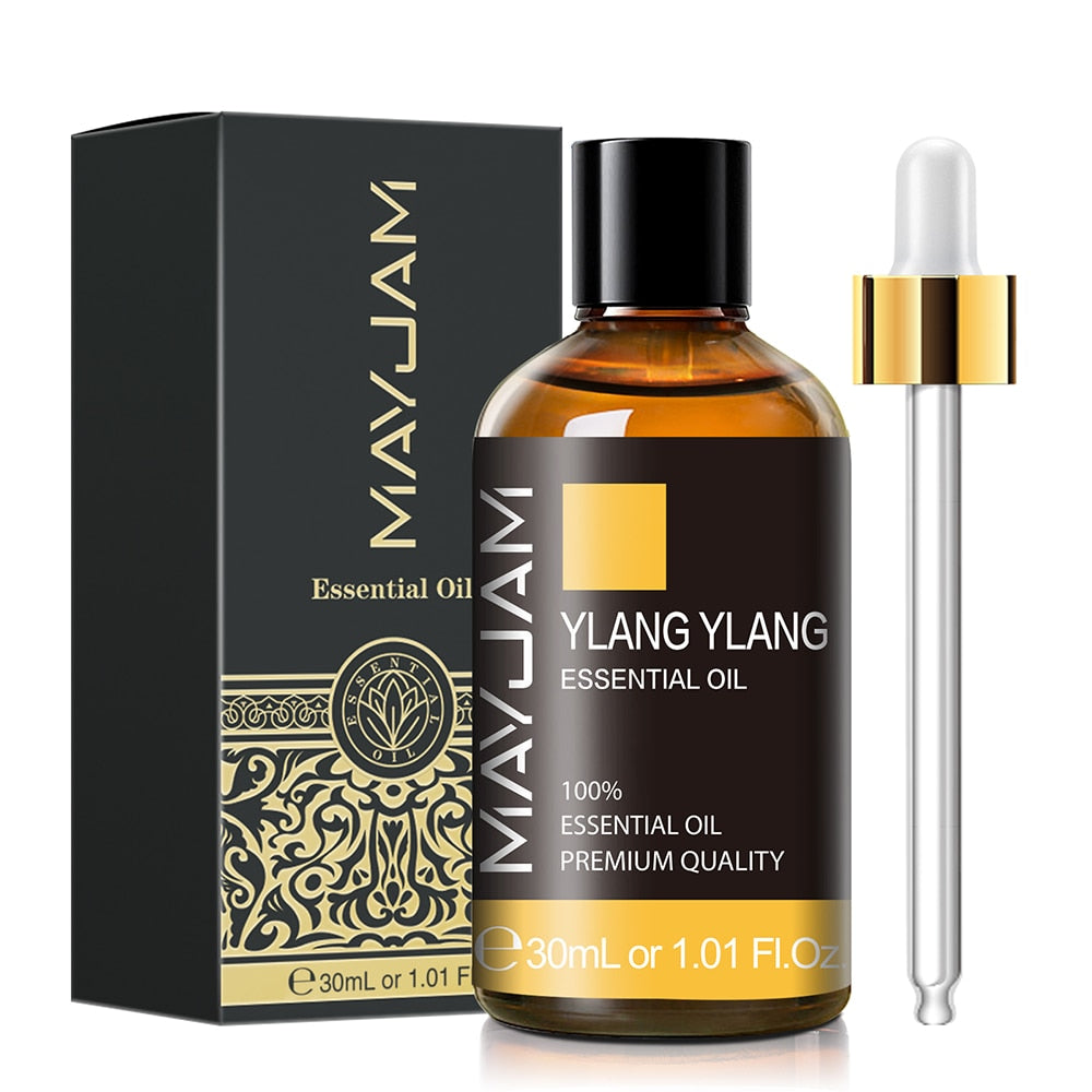 Ylang Ylang essential oil bottle with dropper and packaging on a white background