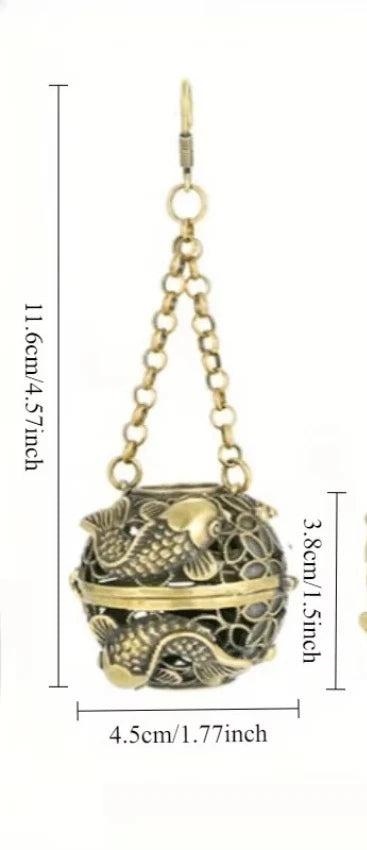 Bronze decorative ball with chain and measurements on a white background