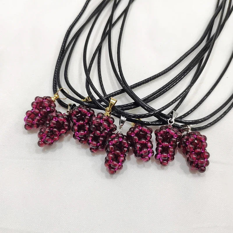 Necklaces with grape-shaped pendants on a white background