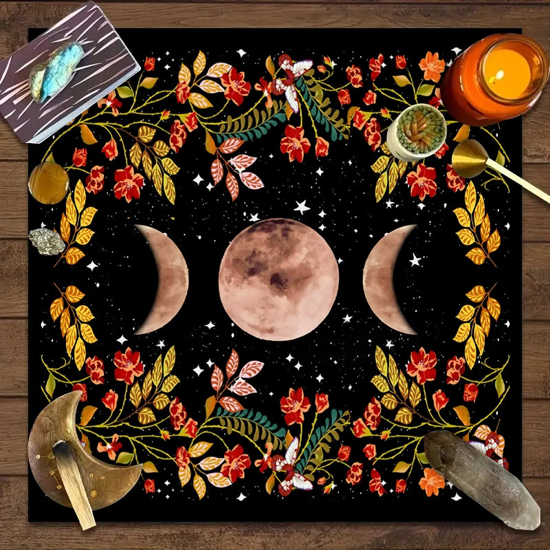 Decorative mat with moon phases, flowers, and candles on a wooden surface