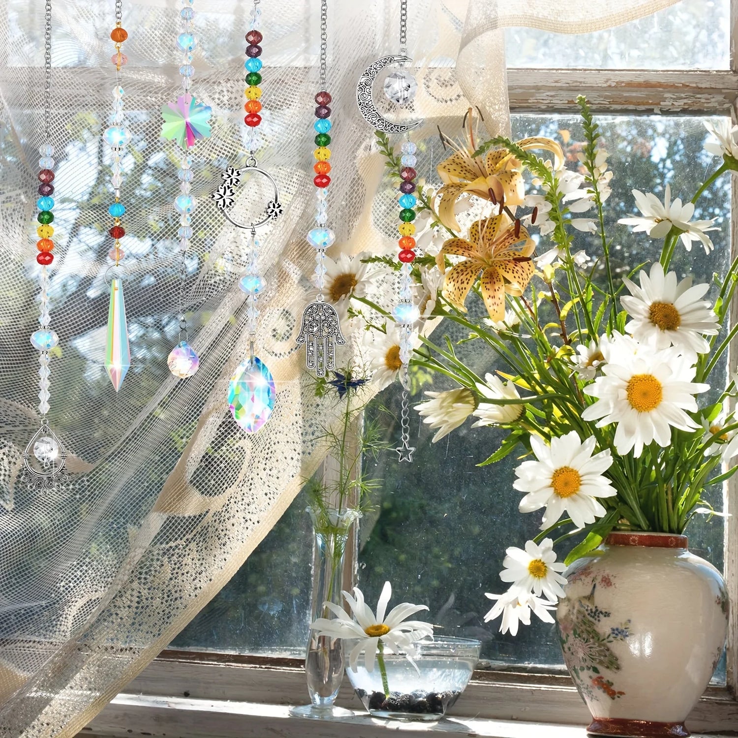 Decorative window with colorful hanging beads, sheer curtain, and a vase of flowers.