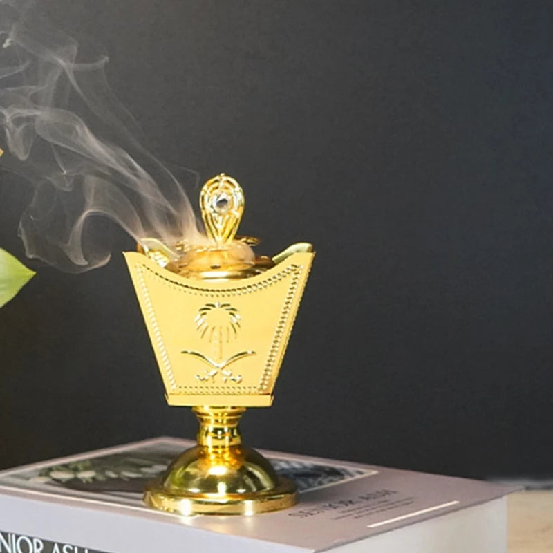 Gold incense burner with smoke on a dark background