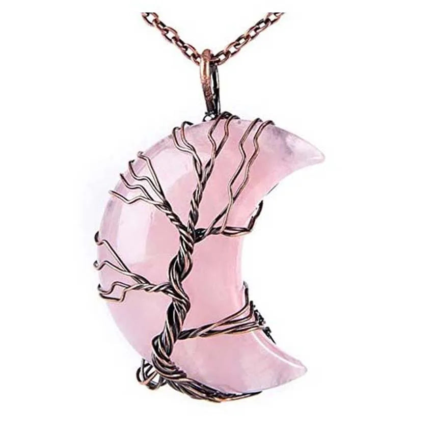 Pink crescent moon pendant with tree design on a white background