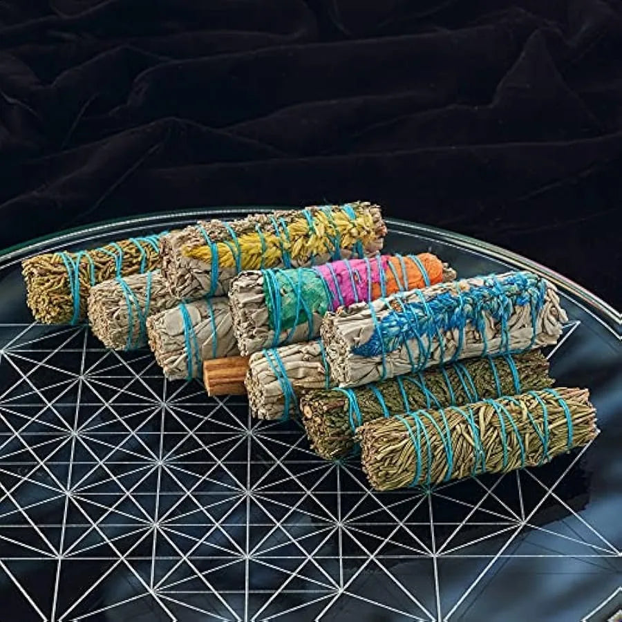 Set of smudge sticks with colorful string on a dark surface