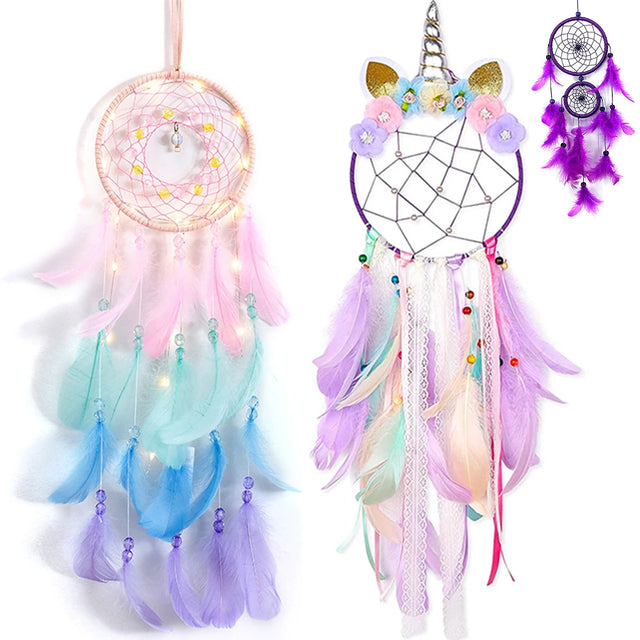 Two colorful dream catchers with feathers and lights on a white background