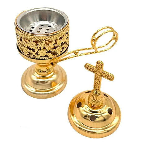 Gold incense burner with cross design on a white background