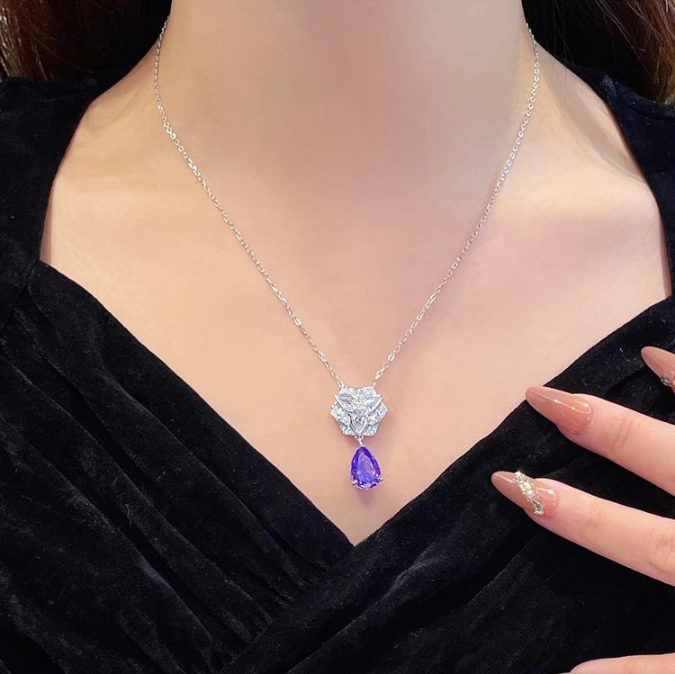 Necklace with a purple gemstone pendant worn by a person in a black outfit, with 'CUMEE' branding.