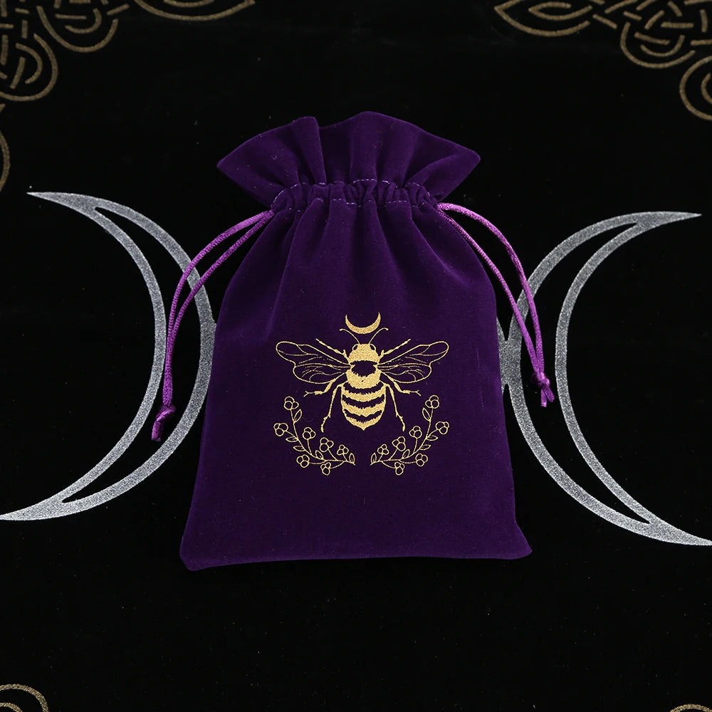 Purple velvet drawstring bag with bee design on a black background with moon phases.