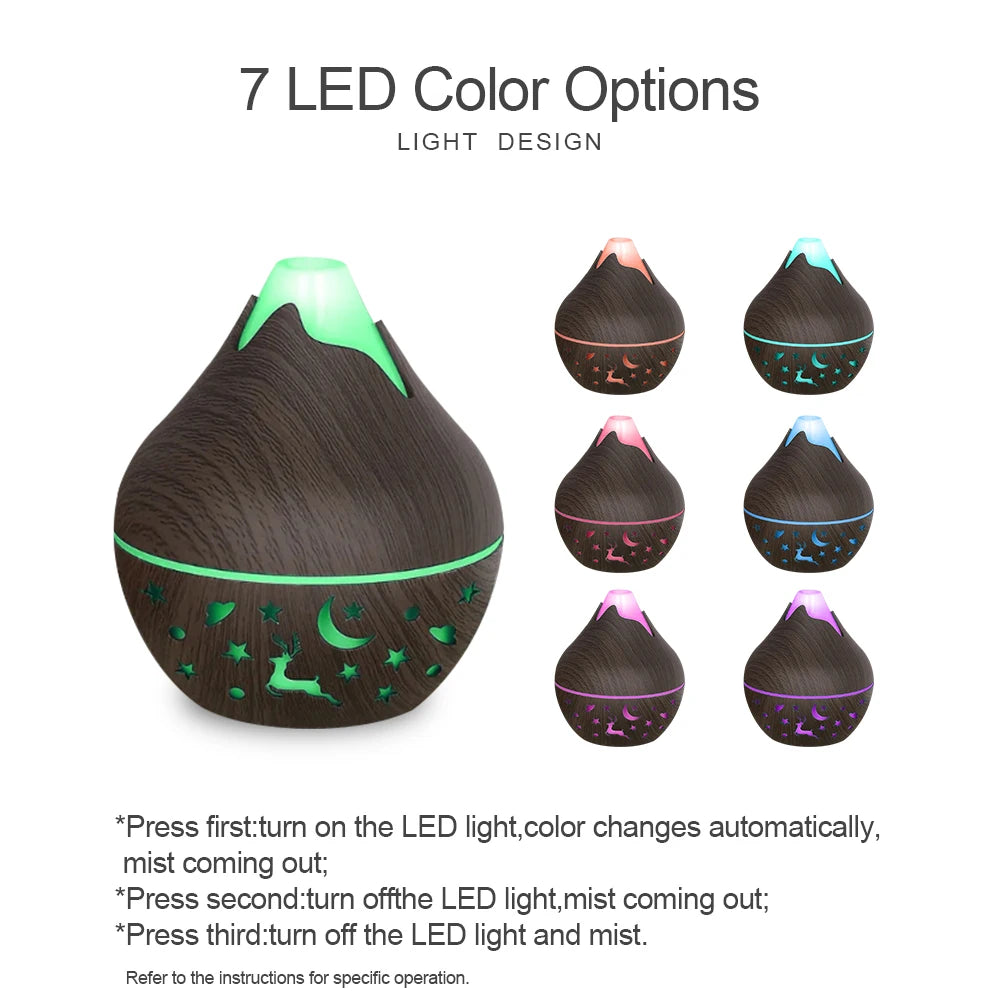 Black essential oil diffuser with LED lights showing 7 color options on a white background.