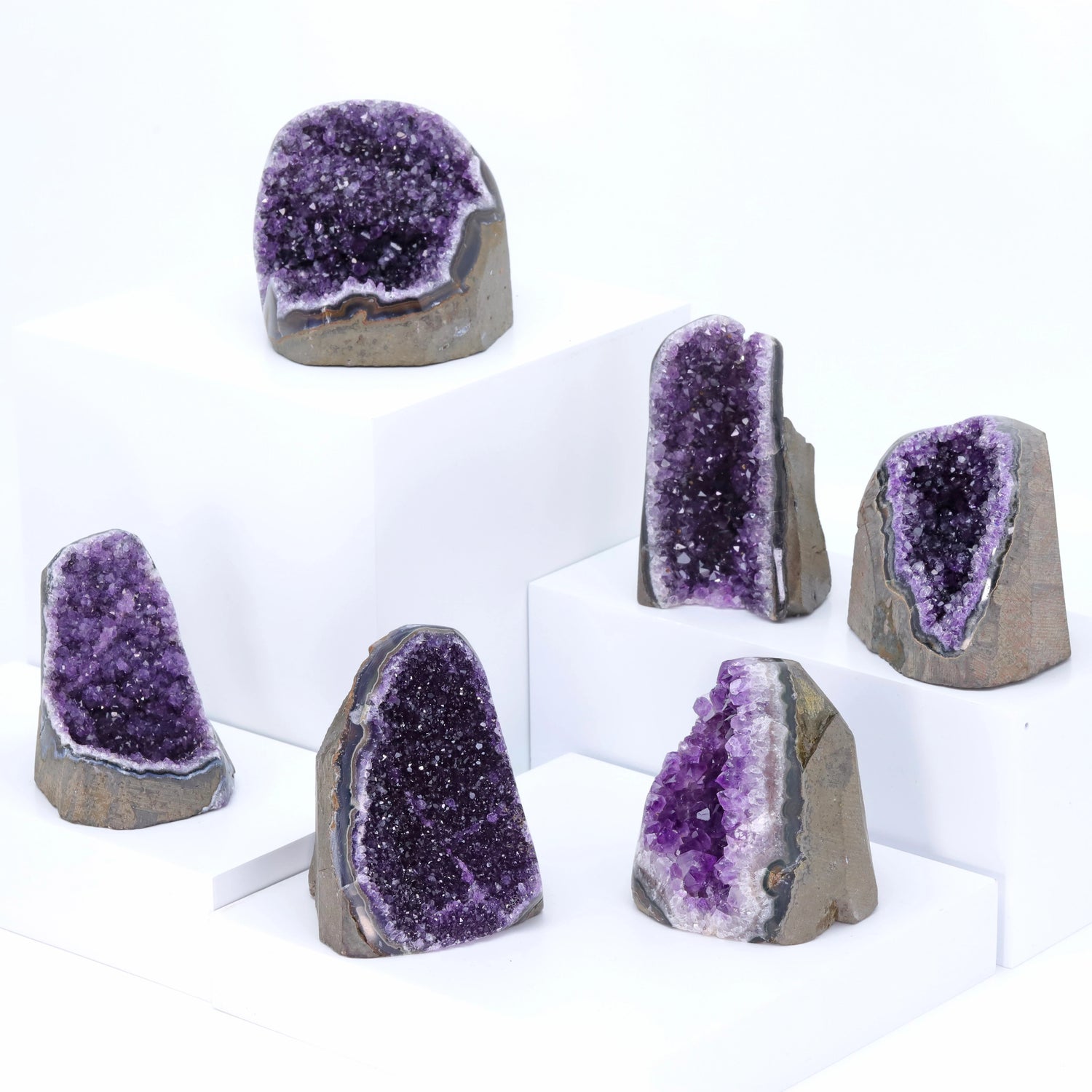 Set of amethyst geodes on a white background