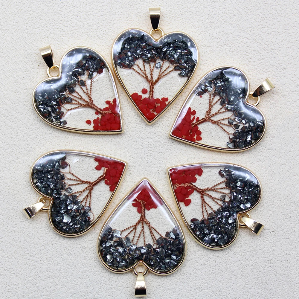 Heart-shaped pendants with nature-themed designs on a light gray background
