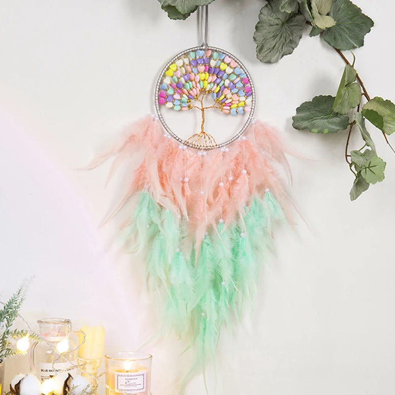 Decorative dreamcatcher with colorful beads and feathers on a white background