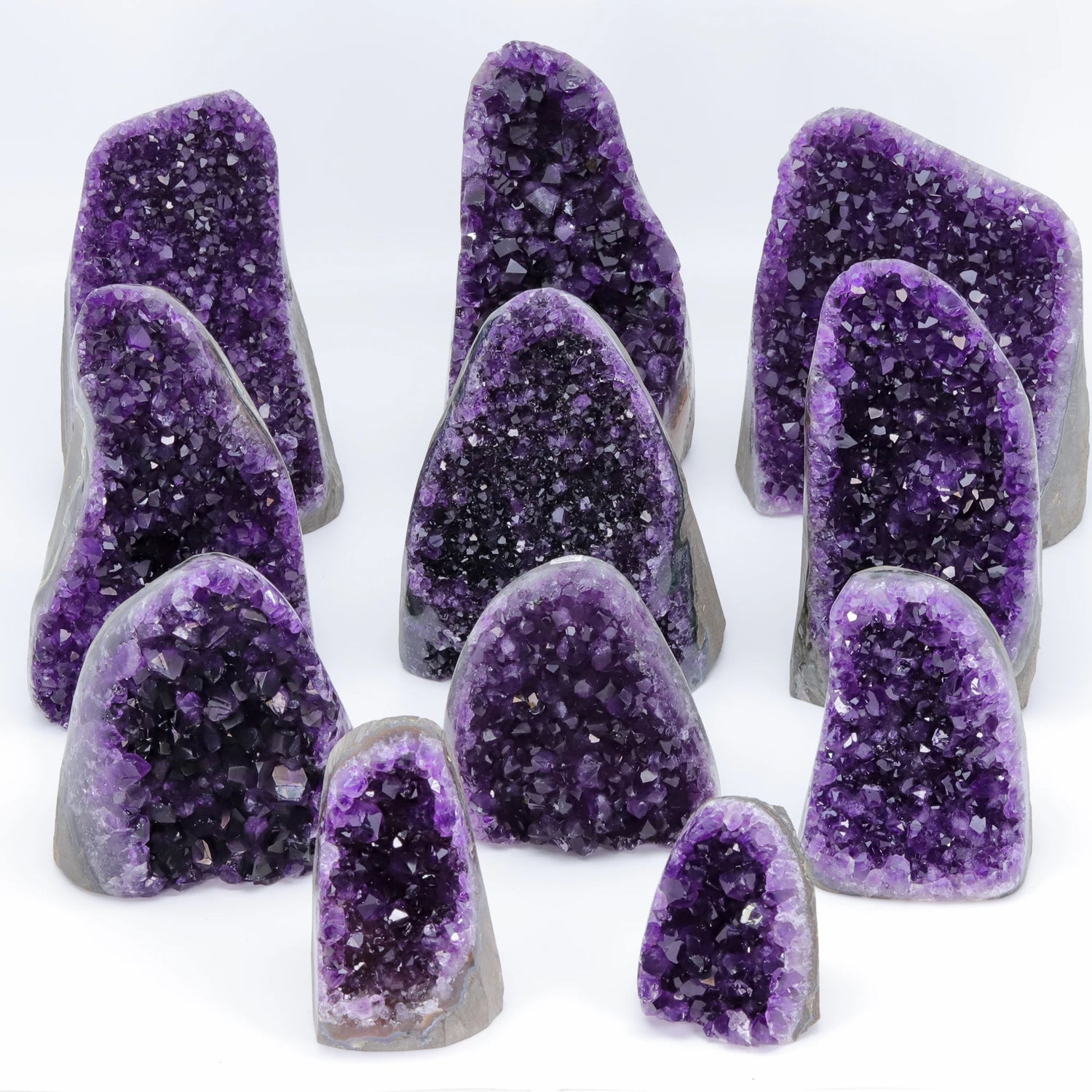 Collection of purple crystal geodes on a white background