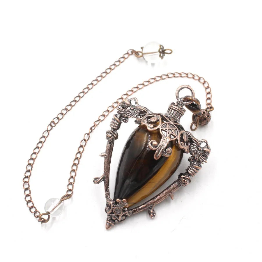 Necklace with a tiger's eye stone and ornate metalwork on a white background