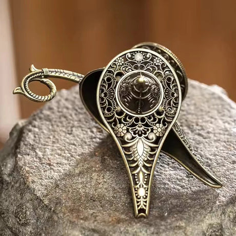 Decorative oil lamp with intricate designs on a stone surface