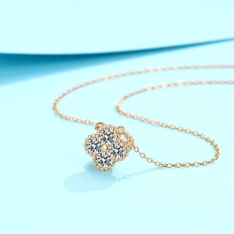 Gold necklace with a heart-shaped diamond pendant on a light blue background