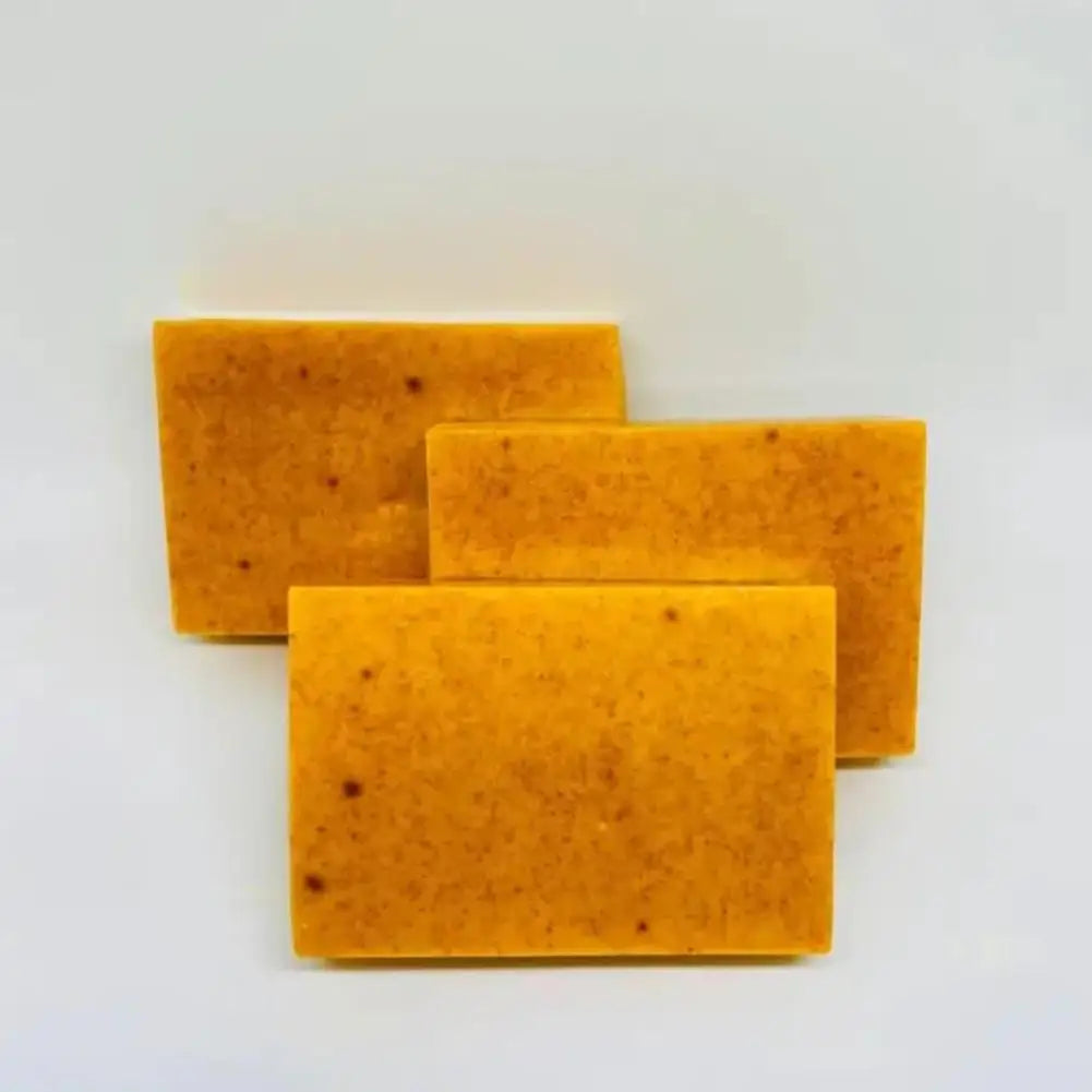 Three rectangular orange soap bars on a white background
