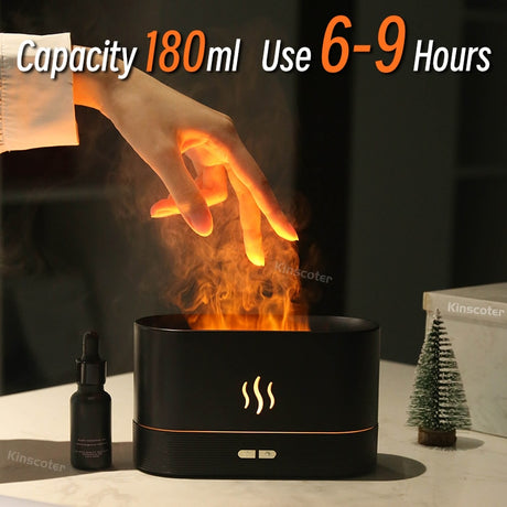 Black essential oil diffuser with flames and text indicating capacity and usage time, placed on a surface.