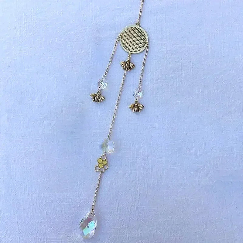 Delicate necklace with floral and bee designs on a light blue background
