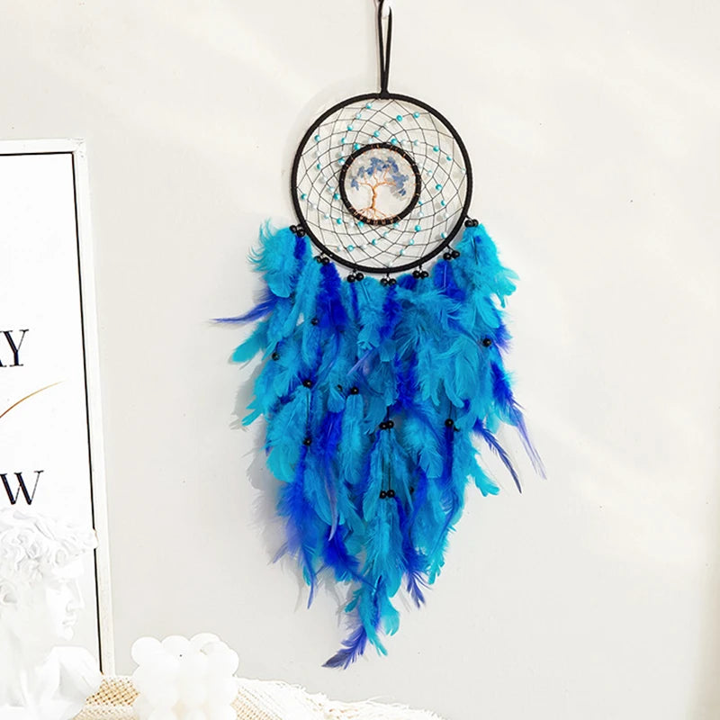 Blue feathered dreamcatcher hanging on a white wall