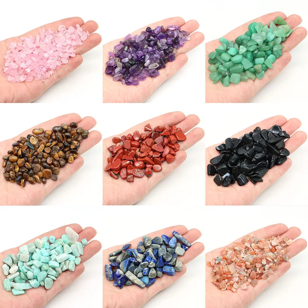Hands holding various types of colorful stones on a white background
