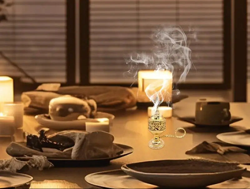 Candlelit dinner table with smoke rising from a candle, blurred background