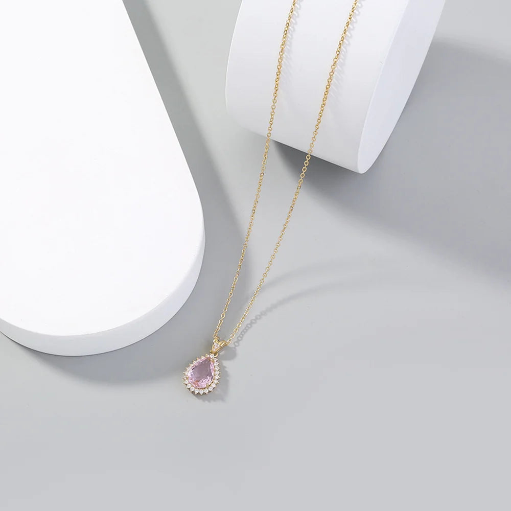 Necklace with a pink teardrop pendant on a light gray background