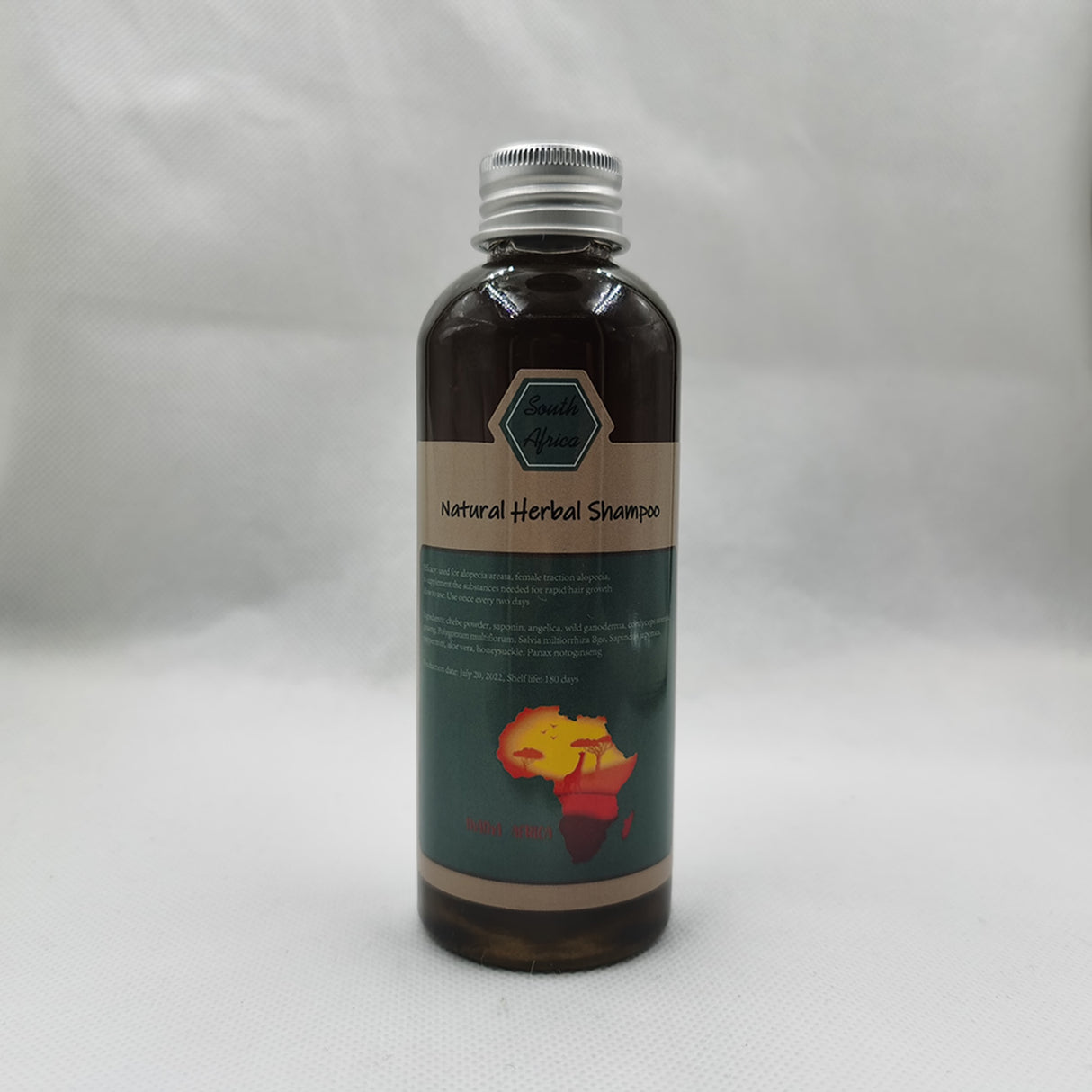 Bottle of natural herbal shampoo with a label on a gray background