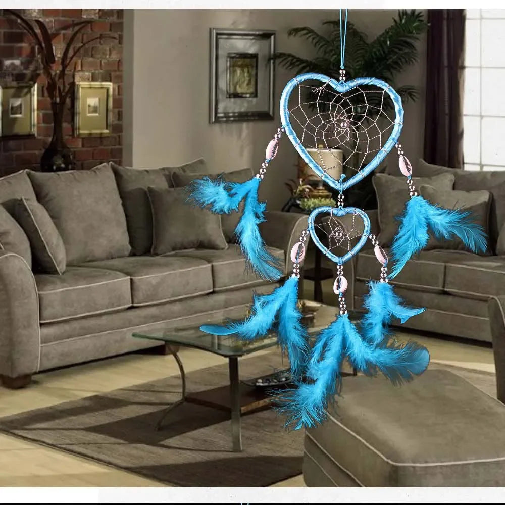 Blue heart-shaped dreamcatcher in a living room setting with gray sofa and decor.