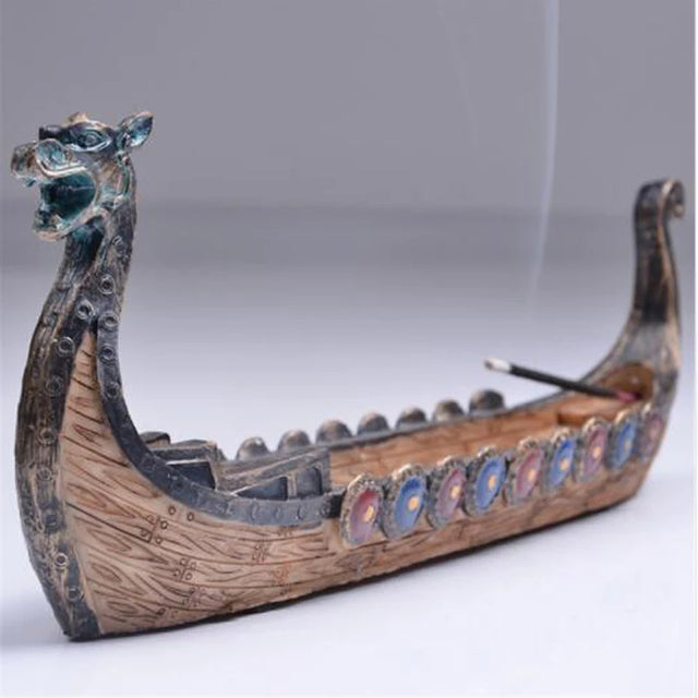 Model of a dragon boat with decorative elements on a plain background