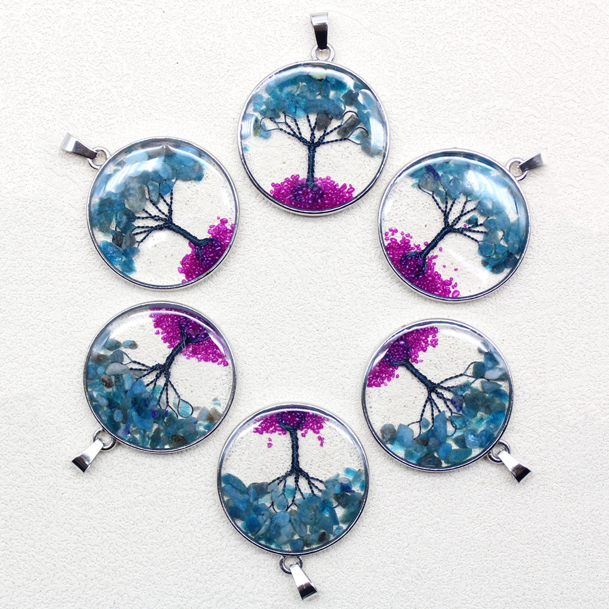 Set of six tree-themed pendants on a white background