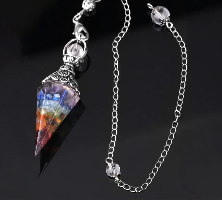 Multicolored crystal pendant on a silver chain with a dark background
