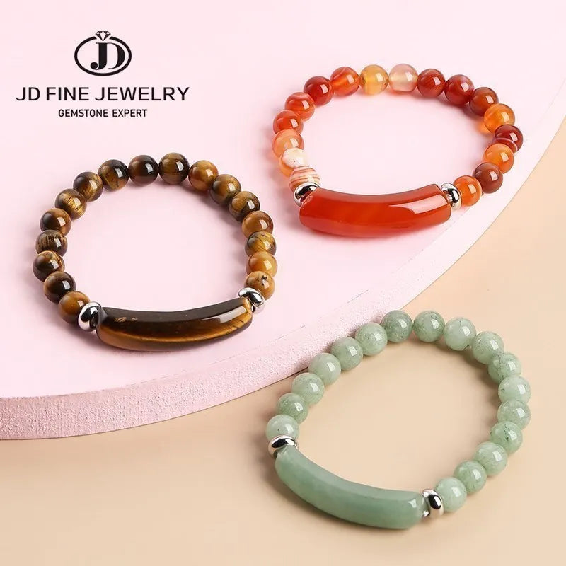 Three beaded bracelets in different colors on a pink and beige background with JD Fine Jewelry logo.