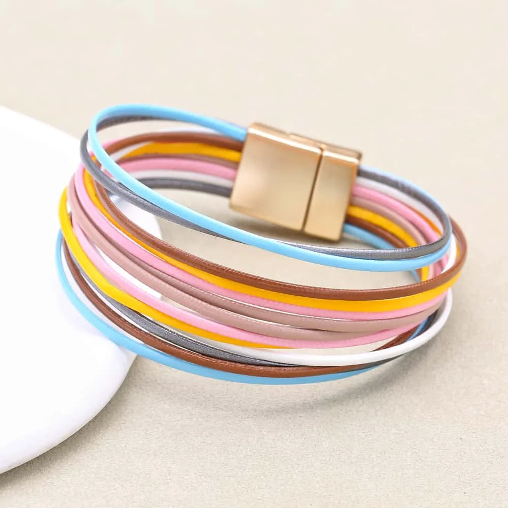 Multicolored bracelet with a gold magnetic clasp on a beige background