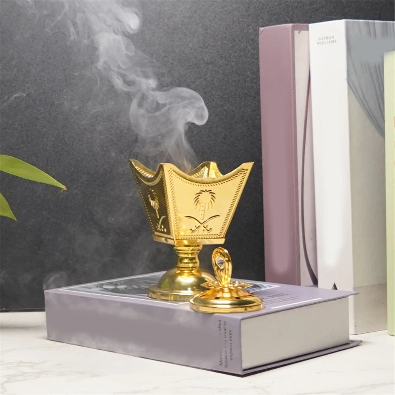 Gold incense burner on a book with smoke rising against a dark background