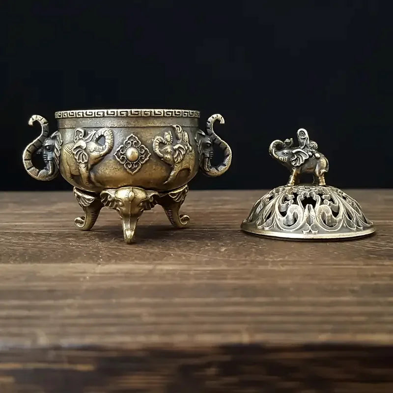 Decorative bronze incense burner with lid on a wooden surface